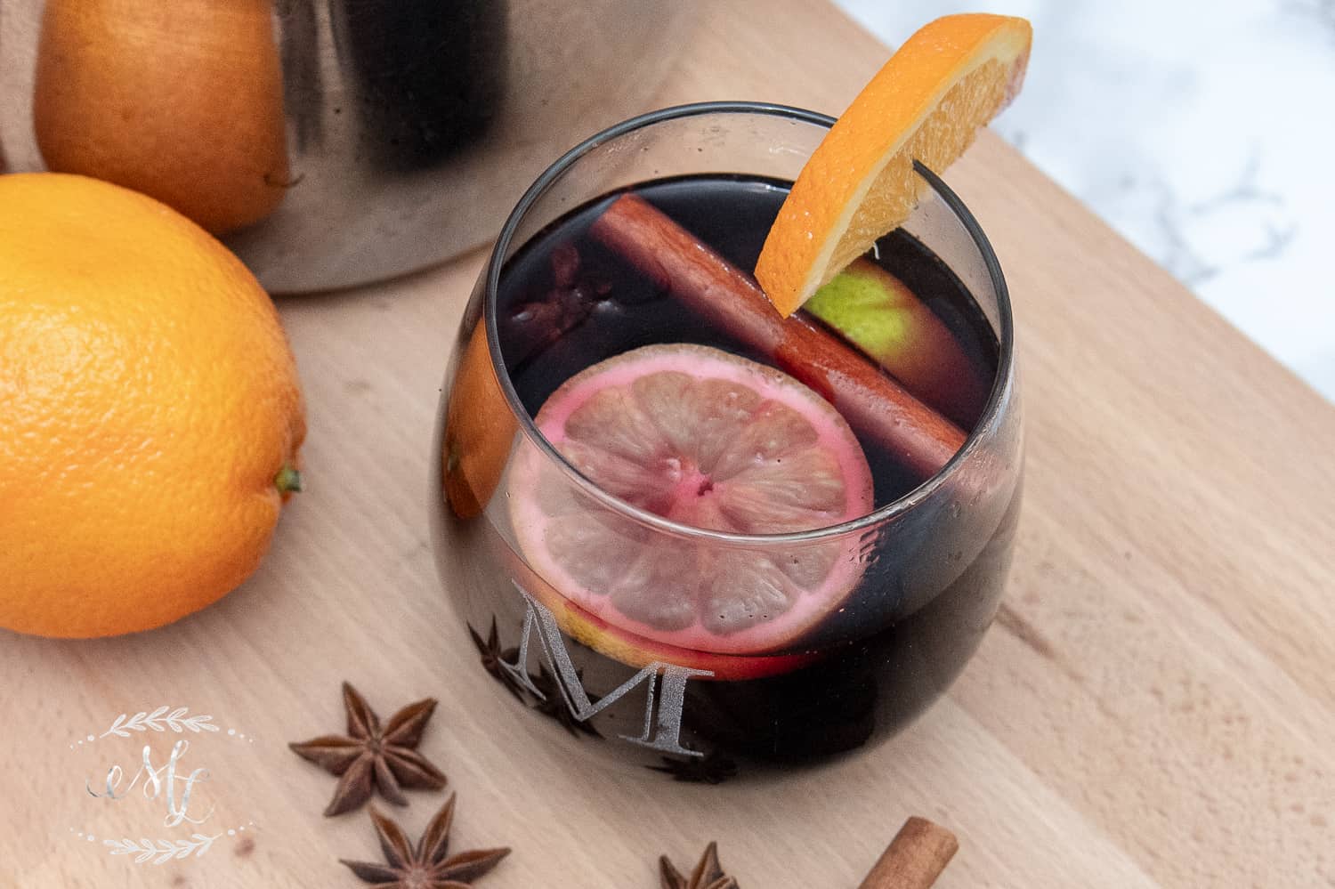 mulled wine garnished with oranges and cinnamon sticks