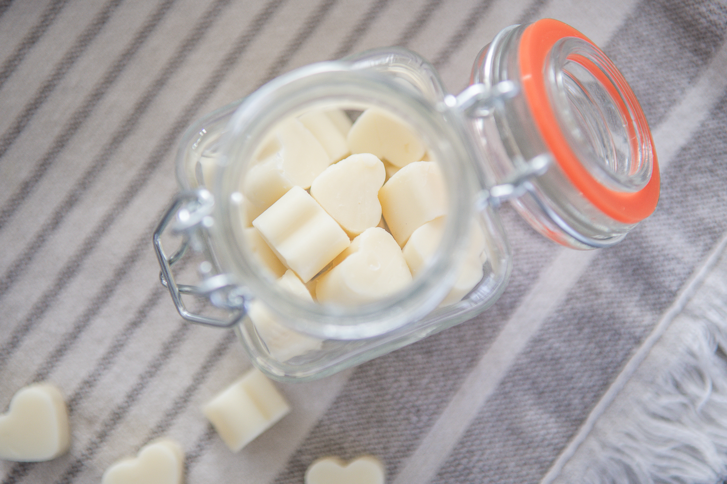 close up look at mini all natural lotion bars in a storage container