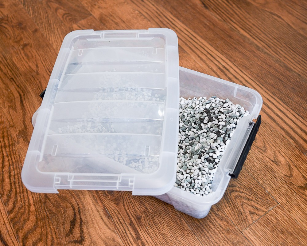 a transparent container on hardwood floor containing plant substrate called pon